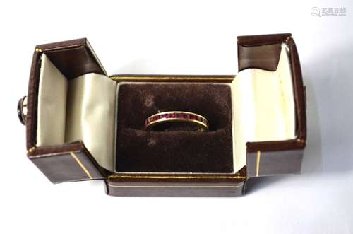 A yellow metal full eternity ring, with channel set rubies, size RSome rubies damaged