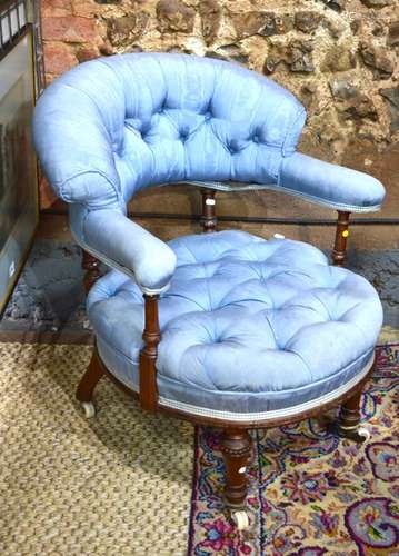 A Victorian walnut framed button blue silk upholstered open elbow chair, raised on white ceramic