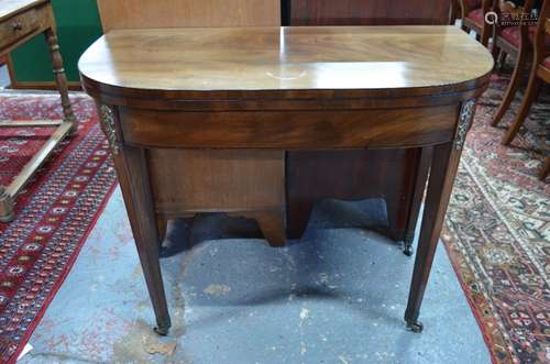 A Victorian figured mahogany fold-over games table, the D-form top raised on double gate legs with