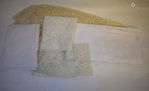 A box of assorted table linen to include circular crocheted cotton thread tablecloth, an embroidered