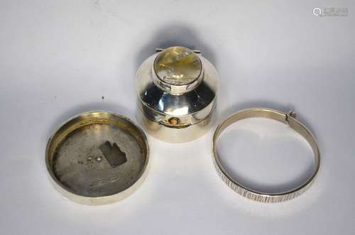 A small contemporary circular silver trinket pot with inset cabochon stone top and button, child's