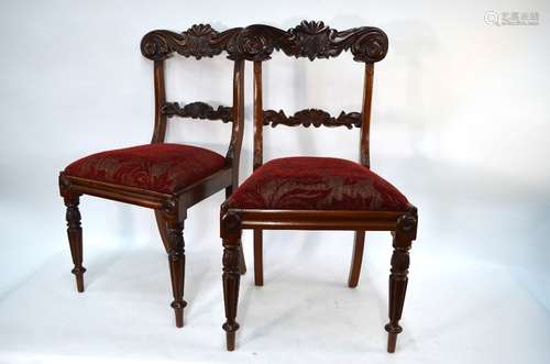 A set of six Regency style mahogany dining chairs with moulded bar backs over fabric seats, raised