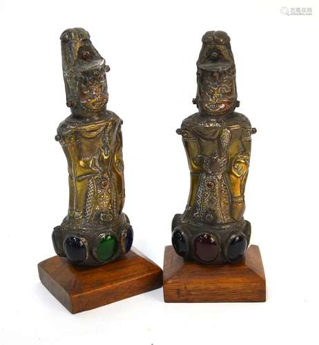 A pair of Asian copper figures of deities, set with semi-precious stones and bosses, 14 cm high (