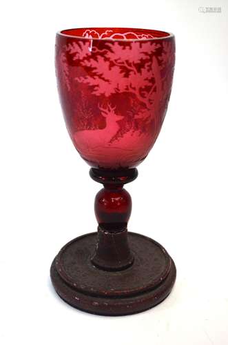 A 19th century Black Forest ruby flash goblet, finely wheel-etched with fox and deer in woodland (