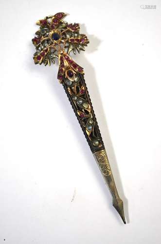 An Indian turban pin mounted as a brooch, white metal set with multi-coloured paste, approx 11.5cm