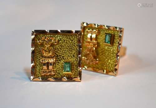 A pair of yellow metal contemporary cufflinks with textured decoration and applied figure, each