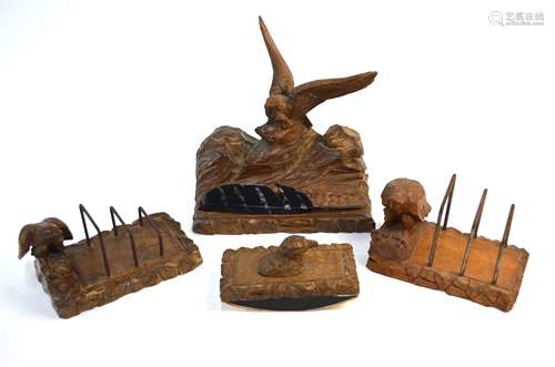 A German Black Forest wood desk set carved with eagles, comprising a pen stand incorporating two ink