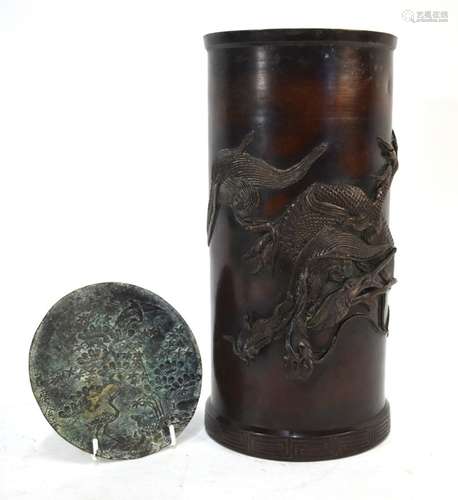 A Japanese cylindrical vessel of brushpot form, decorated in takabori with a dragon; the cylindrical