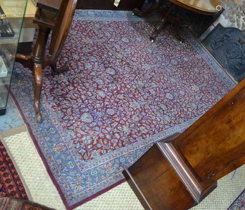 An Indo-Persian Kashan carpet, the floral design on red/brown ground, 295 cm  x 210 cm