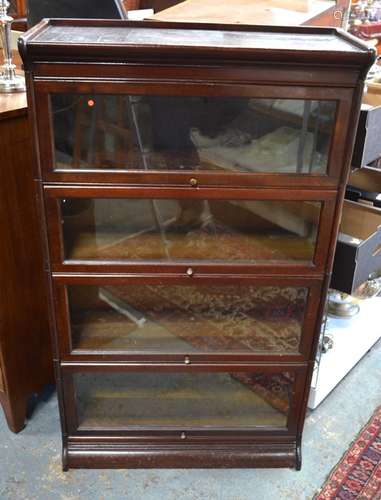 A three glazed section library bookcase in the Globe Wernicke style, on a plinth base to/w another