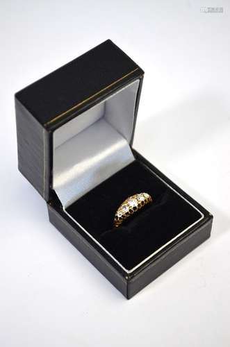 An early 20th century 18ct yellow gold ring set with five old cut graduated diamonds, graduating