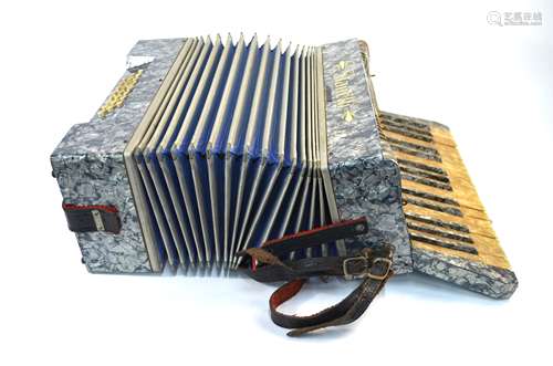 A German Stanelli piano accordion with marbled body and 25 buttons, with case