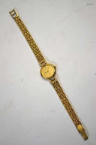 A lady's 9ct Bueche-Girod wristwatch with circular dial flanked by diamond-set shoulders and fancy