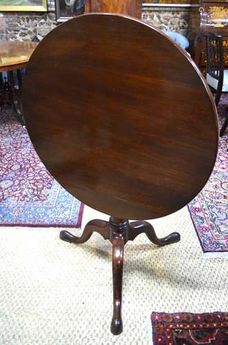 A George II style mahogany tilt top tripod table with birdcage over a gun barrel support, 78 cm diam