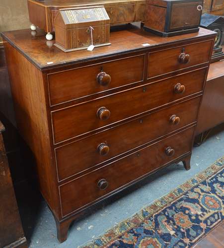 A 19th century mahogany chest of two short over three long graduated drawers with original turned