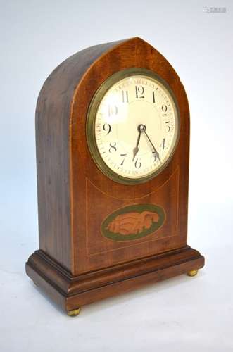 An Edwardian walnut dome cased eight-day mantel clock with white enamelled convex dial and shell