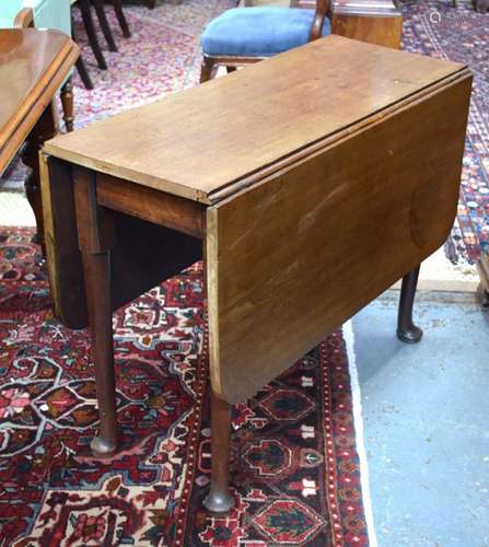 A Georgian mahogany drop leaf supper table raised on turned legs to pad feet