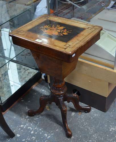 A Victorian walnut work table, the top with inlaid floral urn design hinged to reveal a paper