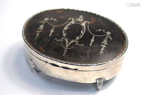 An oval silver, tortoiseshell and piqué-work trinket box with hinged cover and velvet lining, on