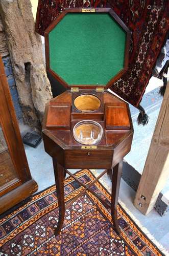 A Victorian mahogany teapoy, the hexagonal body with fitted interior of two lidded rectangular