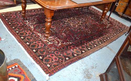 A Turkish carpet, the centre medallion design on brown-red ground, 305 cm x 205 cm