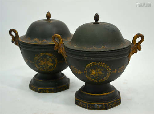 An unusual pair of Regency toleware urn form canisters, the domed covers with pineapple finials