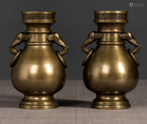 A PAIR OF BRONZE VASES WITH ELEPHANT RING HANDLES