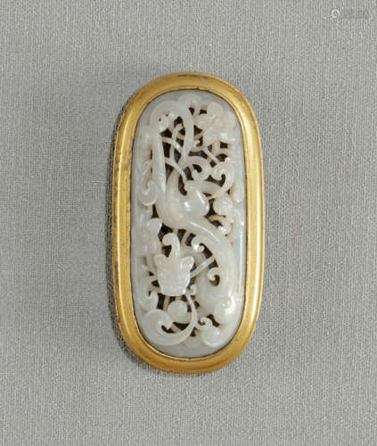 A FINE CARVED JADE PANEL MOUNTED IN A GILT-BRONZE FITTING AS BELT BUCKLE