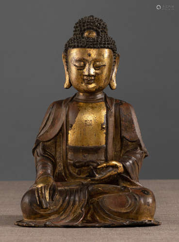 A PARCEL GILT-BRONZE FIGURE OF BUDDHA SHAKYAMUNI