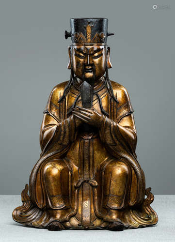 A FINE GILT-BRONZE FIGURE OF A SEATED DAOIST DIGNITARY