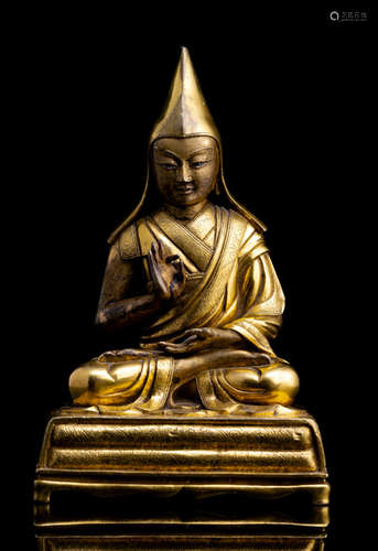 A VERY FINE GILT-BRONZE FIGURE OF A LAMA