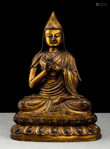 A GILT-BRONZE FIGURE OF A LAMA