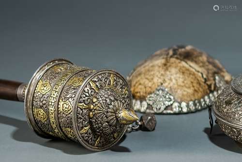 A PARCEL-GILT SILVER AND WOOD PRAYER WHEEL AND A LOW-ALLOY SILVER AND BONE KAPALA