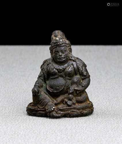 A RARE IRON FIGURE OF JAMBHALA