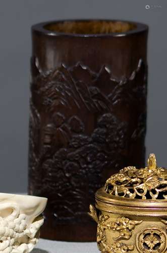 A DARK-BROWN COLORED CARVED BAMBOO LANDSCAPE BRUSHPOT