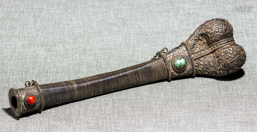 A SILVER-DECORATED BONE TRUMPET