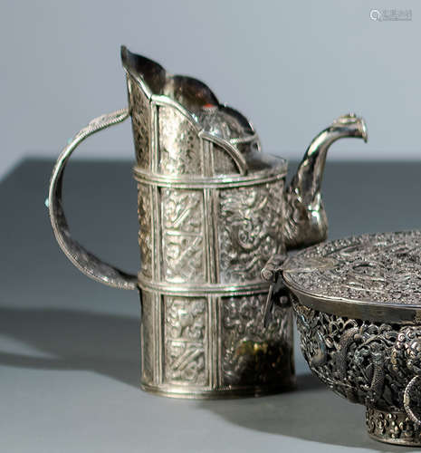 A SILVER EWER AND COVER IN TIBETAN STYLE