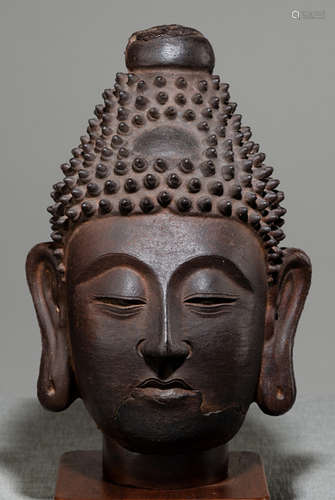 A CAST-IRON HEAD OF BUDDHA