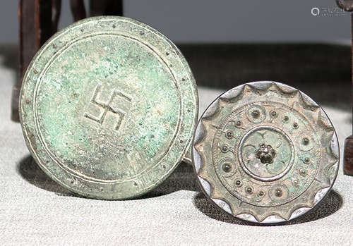 A BRONZE MIRROR WITH A SWASTIKA SYMBOL AND A SMALL BRONZE MIRROR