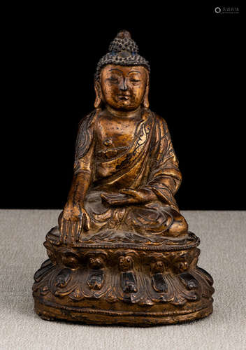 A GILT- AND BLACK-LACQUERED BRONZE FIGURE OF BUDDHA SHAKYAMUNI