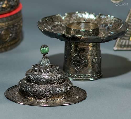 A SILVER TEACUP STAND AND COVER