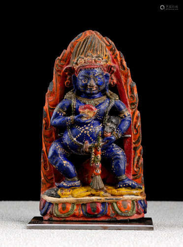 A POLYCHROME STONE FIGURE OF JAMBHALA