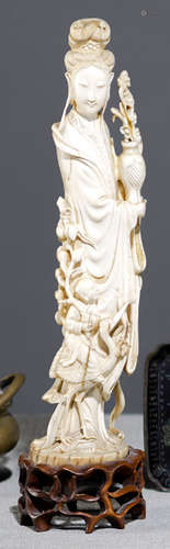 A WELL CARVED IVORY MODEL OF A FEMALE IMMORTAL WITH CRANE