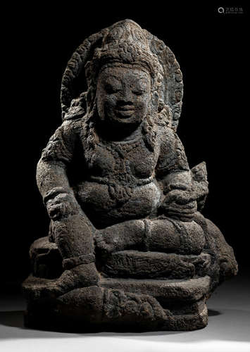 A VOLCANIC STONE FIGURE OF KUBERA