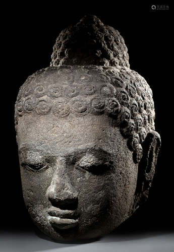 AN OVER-LIFE SIZE VOLCANIC STONE HEAD OF BUDDHA SHAKYAMUNI