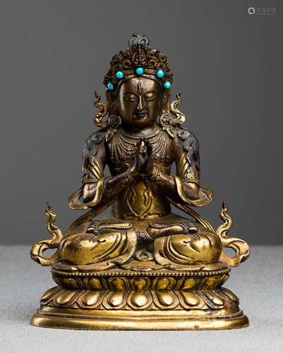 A FINE PARCEL-GILT BRONZE FIGURE OF GUANYIN; TIBETO-CHINESE