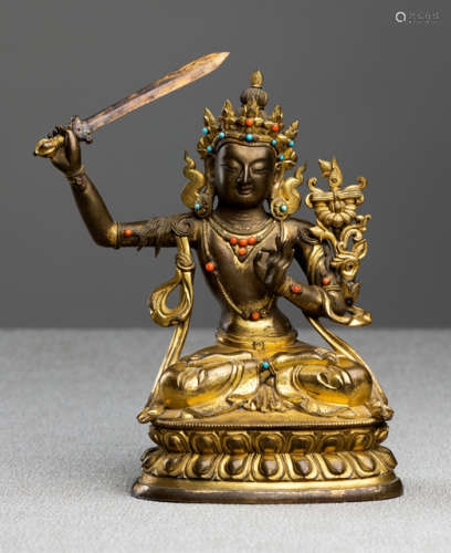 A PARCEL-GILT BRONZE FIGURE OF MANJUSHRI