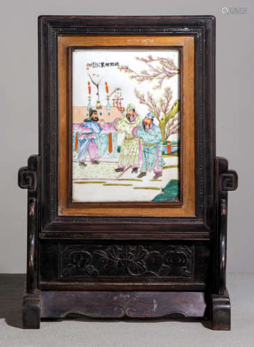 A WOODEN TABLE SCREEN WITH A POLYCHROME PORCELAIN PANEL