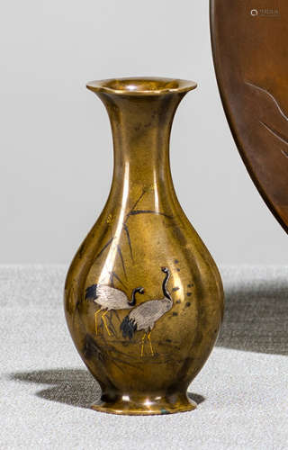 A LOBED BRASS VASE WITH INLAID DECORATION OF A PAIR OF CRANES AND WEED