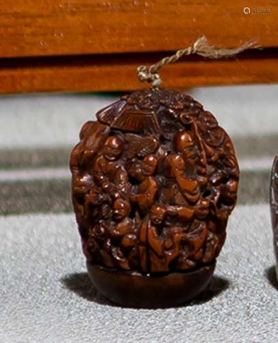 A FINE CARVED TWO-PART NUT WITH IMMORTALS